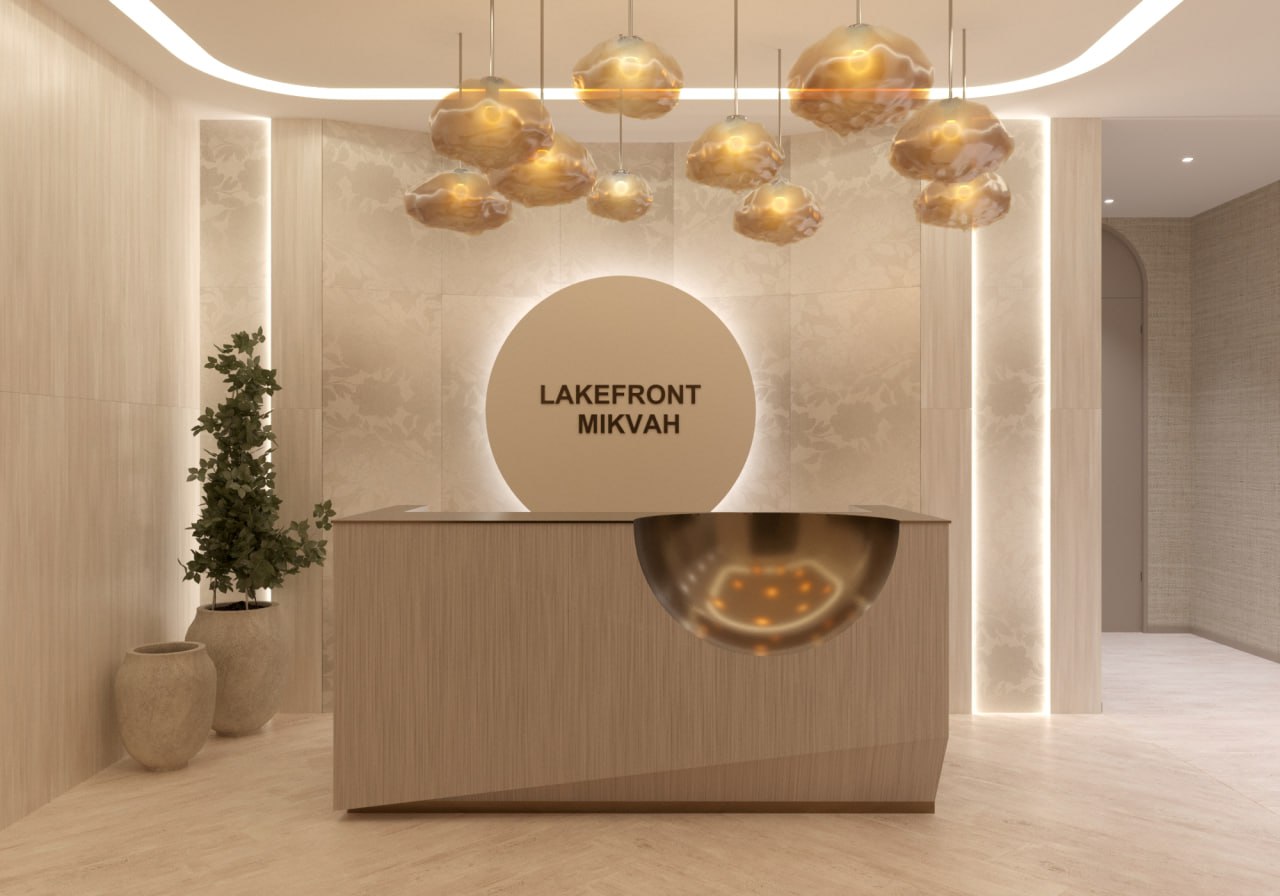 Reception lounge with travertine walls and warm bronze detailing